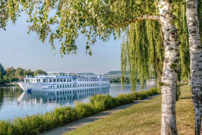 River cruise ship docked along a Dutch canal, bike and barge holiday in the Netherlands.