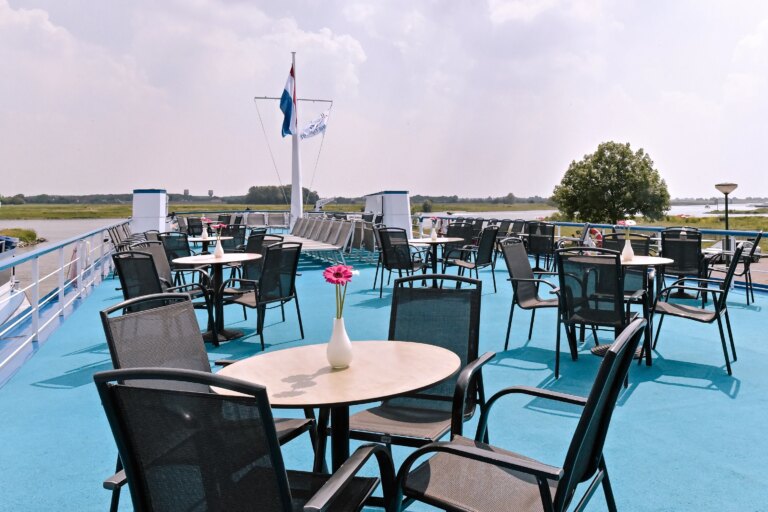 Sundeck equipped with tables and chairs.