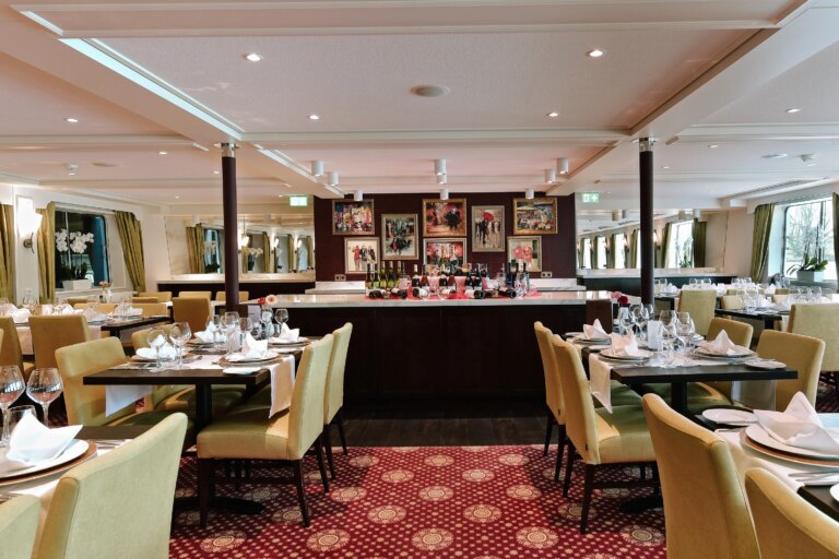 Elegant dining room with set tables on a European river cruise ship.