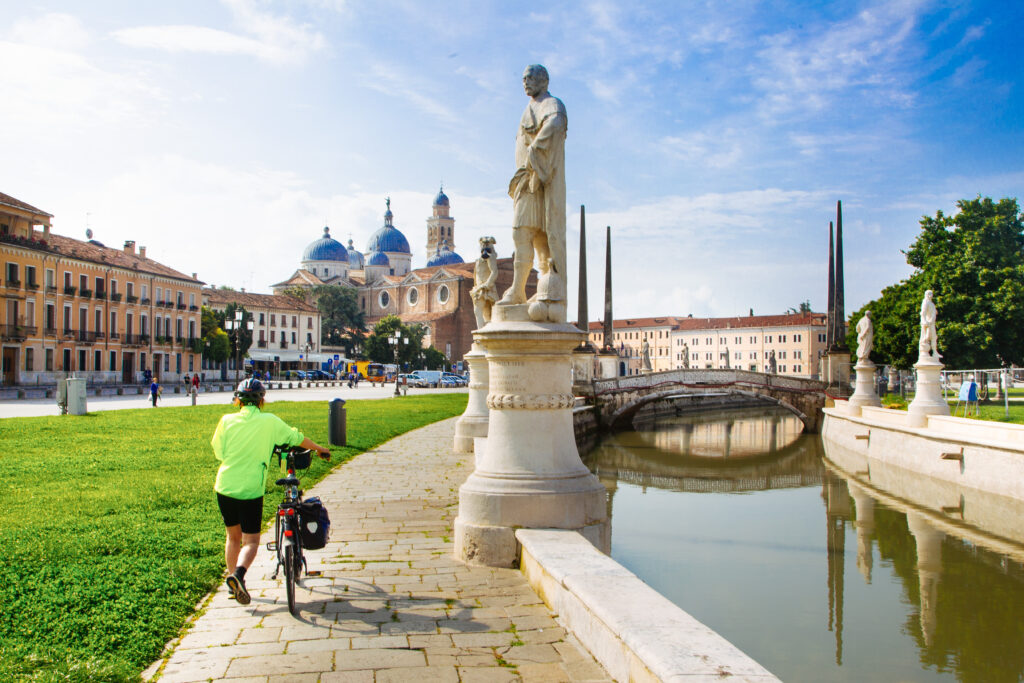 Cyclist, cycling holidays, slow tourism, Prato della Valle statues, Padua